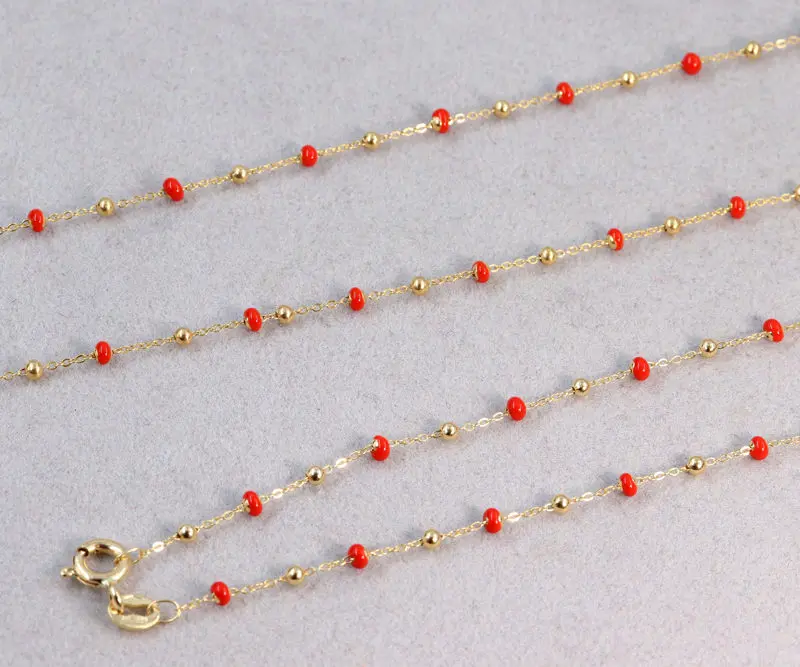 Ensemble collier et bracelet boules d'or et boules émail orange